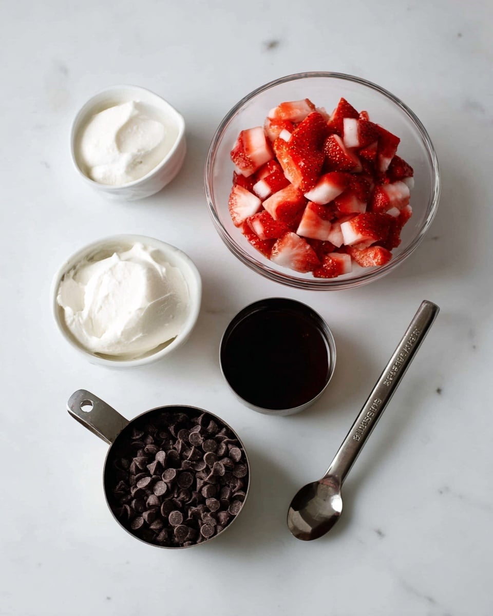 The image shows five main food items arranged separately on a white marbled surface. In the center, there is a clear glass bowl filled with small, bright red and white pieces of chopped strawberries. To the right of the bowl, there is a metal teaspoon filled with dark liquid, likely vanilla extract. Below the bowl, there is a metal measuring cup filled with small, dark brown chocolate chips. To the left, there is a metal measuring cup holding smooth, white cream or yogurt. Above this, there is a small white bowl with a soft, solid white substance that looks like coconut oil. Photo taken with an iphone --ar 4:5 --v 7
