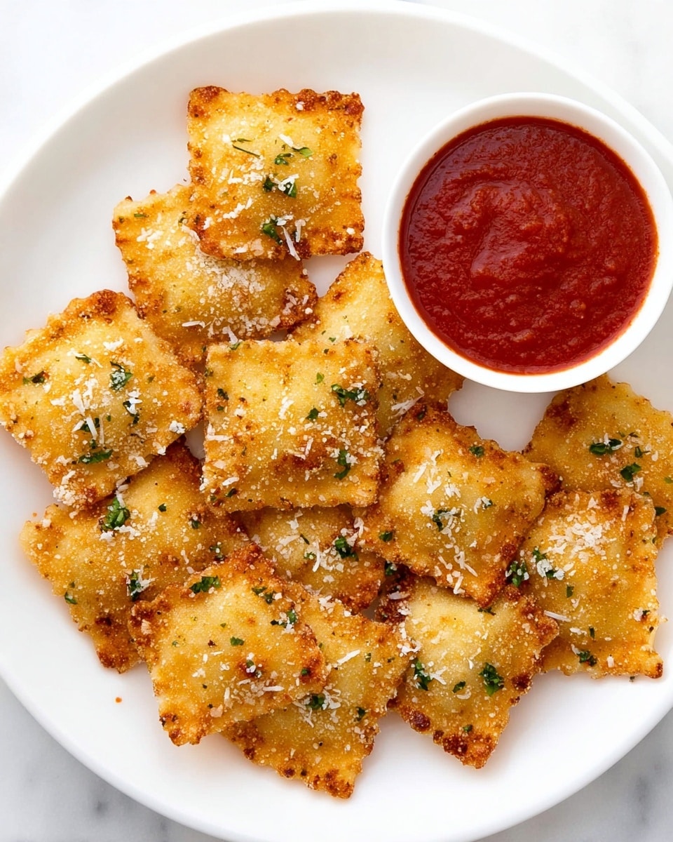 A white plate holds nine crunchy golden-brown fried ravioli pieces with a rough, crispy texture. Each ravioli is square and sprinkled with small green herb bits and white cheese shreds. On the top right of the plate, there is a small white bowl filled with thick red marinara sauce that looks smooth with soft tomato chunks. The plate sits on a white marbled surface. photo taken with an iphone --ar 4:5 --v 7