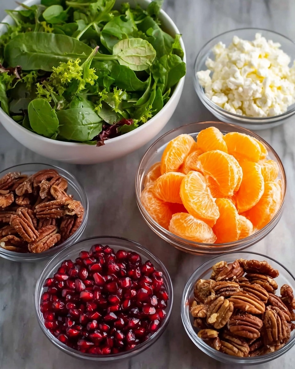 There are five white bowls placed on a white marbled surface. The largest bowl at the back holds fresh green leafy salad with different shades of green leaves. In front and center is a medium bowl filled with bright orange peeled mandarin slices, smooth and shiny. To the right of the mandarins is a smaller bowl full of white crumbly cheese. Below the cheese bowl is another small bowl containing brown chopped pecans with a slightly rough texture. On the left bottom corner, there is a bowl filled with shiny, deep red pomegranate seeds. The bowls are made of clear glass, showing the colorful ingredients inside clearly, photo taken with an iphone --ar 4:5 --v 7