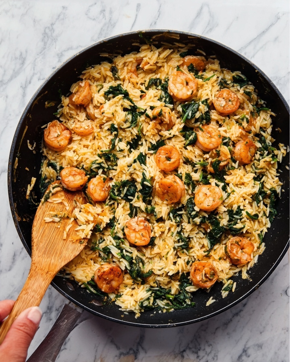 The image shows a black pan filled with a dish made of orange shrimp, light yellow rice, and dark green spinach mixed together evenly. The shrimp pieces are round and scattered through the dish, sitting on top of and inside the bed of fluffy rice, which forms the main base layer. The spinach leaves are distributed throughout, adding rough texture and color contrast. A woman's hand holding a wooden spatula is visible on the left side of the pan, as if stirring the food. The pan rests on a surface with a white marbled texture. Photo taken with an iphone --ar 4:5 --v 7