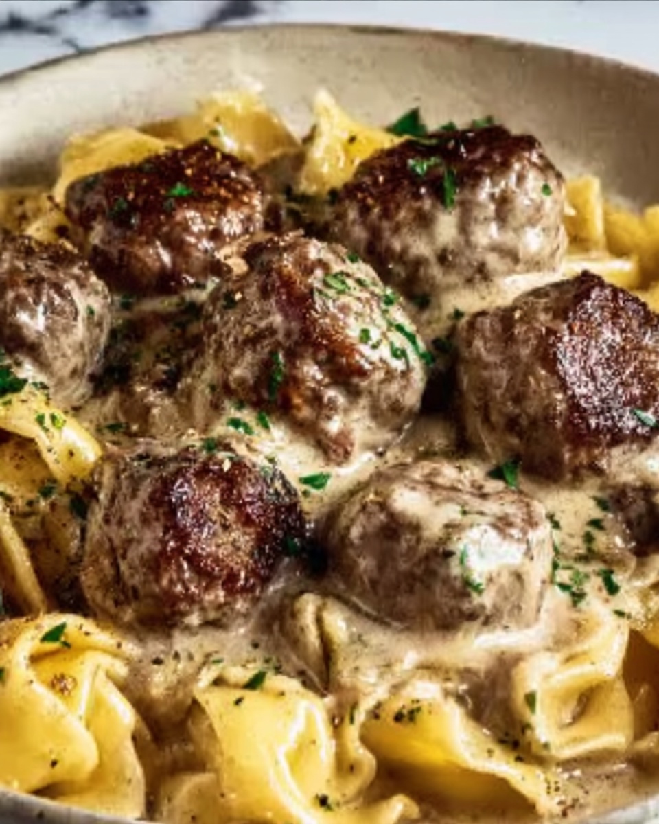 This image shows a white bowl filled with several layers of food. The base layer is composed of yellow tortellini pasta, soft and rounded with pockets of filling inside. Mixed throughout and on top are medium to dark brown pieces of cooked meat that look tender and slightly seared. Green bits of cooked spinach are spread evenly around the dish, adding color contrast. The entire dish is coated in a creamy sauce that is light beige in color, giving it a smooth and rich appearance. Small specks of black pepper and possibly some grated cheese are sprinkled on the top for texture and visual interest. The bowl sits on a white marbled surface. Photo taken with an iphone --ar 4:5 --v 7