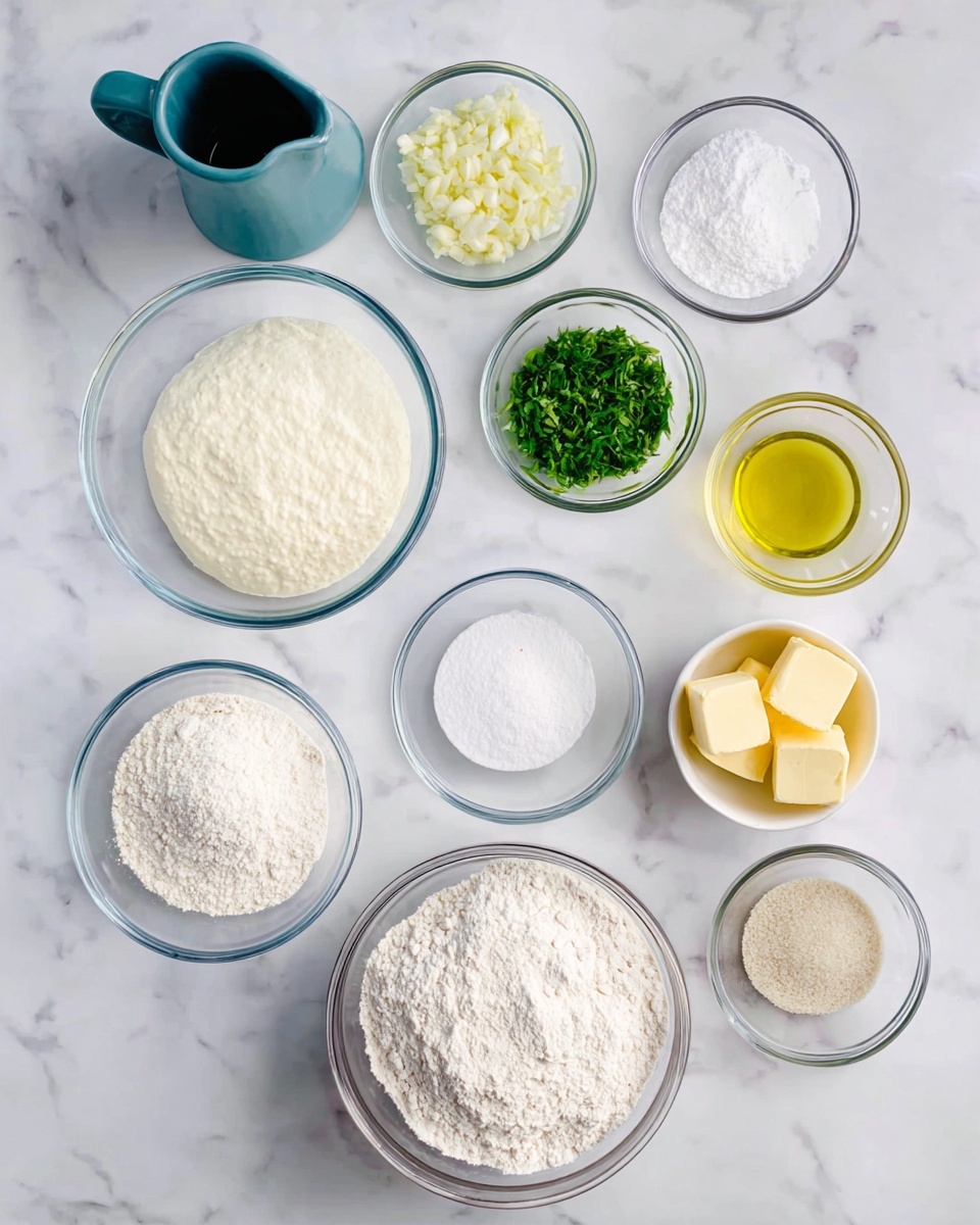 The image shows eleven clear glass bowls and a blue-gray pitcher arranged on a white marbled surface. In the bottom center, there is a big bowl filled with white flour. To its left, a medium bowl has a thick white cream, and next to that is a smaller bowl with white granulated sugar. Above these, a small bowl holds minced garlic, and beside it is a similar bowl with white chopped pieces, likely garlic cloves. Above those sits a bowl of bright green chopped herbs. On the right side, a medium bowl contains light golden yellow oil, and below it, a small bowl with dry yeast granules. Above the yeast is a small bowl with a white granulated substance, maybe salt. Next to the herbs, there is a small bowl with three pieces of yellow butter. The blue-gray pitcher on the far left adds height to the arrangement. The overall setup is clean and organized. photo taken with an iphone --ar 4:5 --v 7