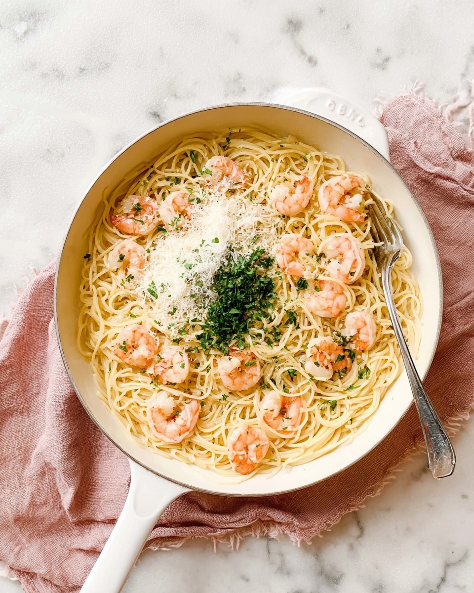 A white pan filled with thin yellow pasta noodles spread evenly as the base layer. On top of the noodles, there are several pink shrimp scattered around. There is a sprinkle of white grated cheese piled lightly on one side near the center, and a small mound of finely chopped green herbs next to the cheese. The pan is set on a textured white marbled surface with a soft pink cloth placed underneath the pan's handle. A silver fork is resting partially in the pan from the top right side. Photo taken with an iphone --ar 4:5 --v 7