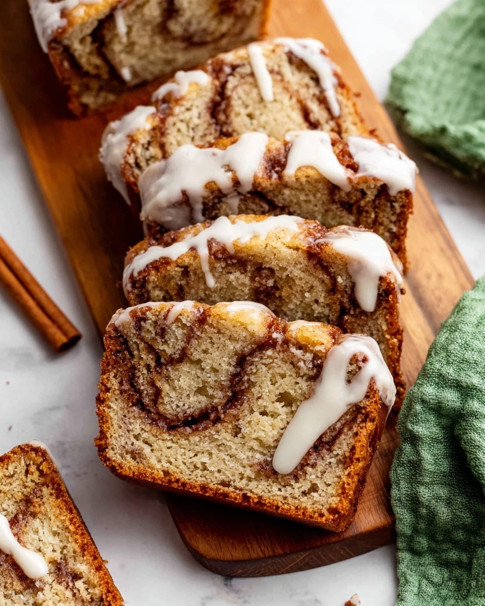 The image shows several thick slices of cinnamon swirl quick bread with a light brown color and visible cinnamon layers inside the bread. Each slice is topped with a white icing drizzle that runs down the sides unevenly. The slices are laid on a white marbled surface with a wooden cutting board beneath some of the slices, adding a warm contrast. On the left side, a cinnamon stick lies on the surface and a green cloth napkin is placed on the right edge. The texture of the bread looks soft and moist with a slightly rough crust. Photo taken with an iphone --ar 4:5 --v 7