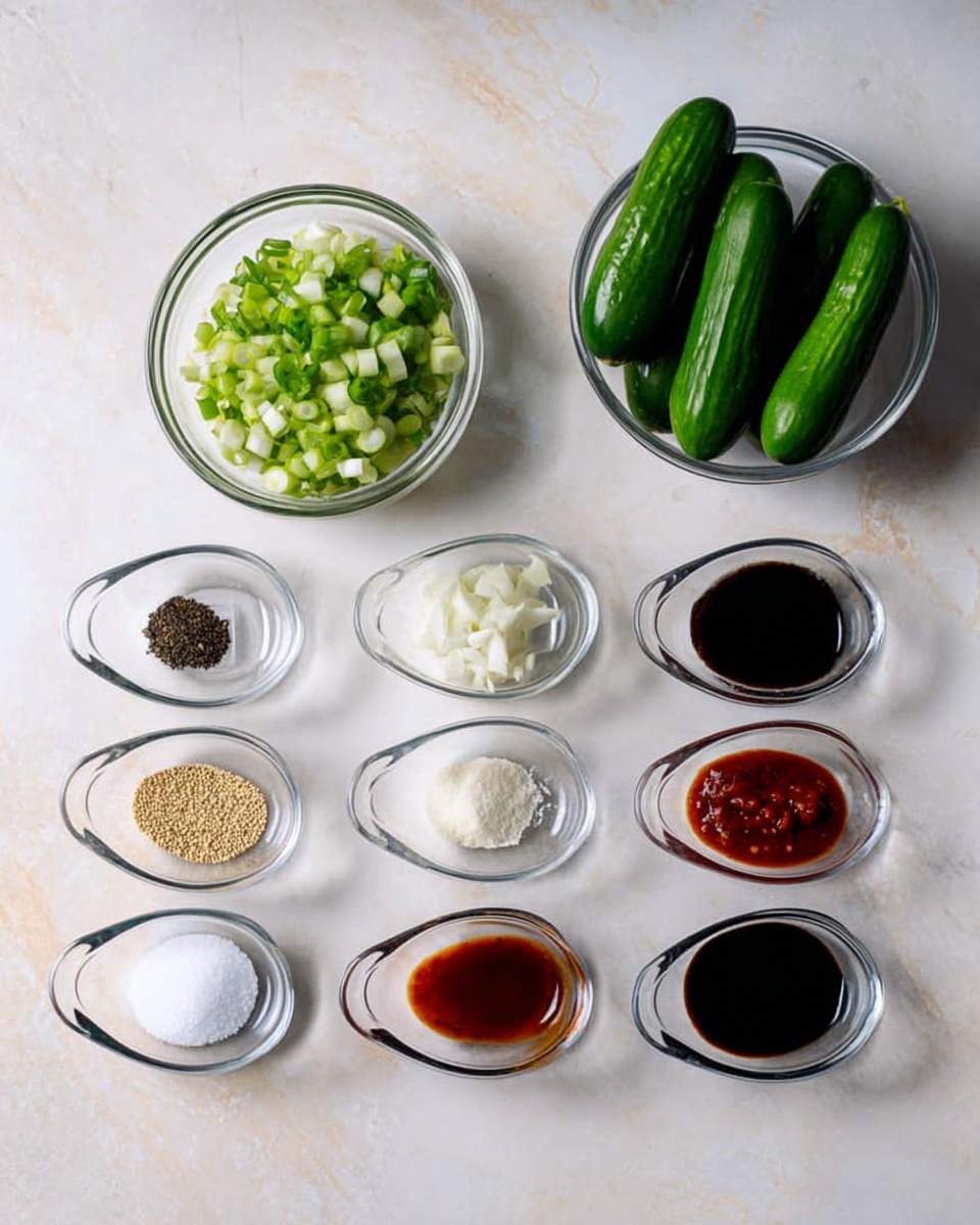 The image shows a white marbled surface with several clear glass bowls arranged neatly, containing different cooking ingredients. At the top right is a larger bowl holding six small green cucumbers. Next to it on the left is a smaller bowl filled with chopped green onions. Below these, there are eight small oval bowls lined up in two rows with various ingredients: the top row includes black pepper, sesame seeds, chopped garlic, and salt; the bottom row includes soy sauce, white vinegar, red chili paste, and sugar. The bowls and their contents are clearly visible and distinct, creating a clean and organized look. Photo taken with an iphone --ar 4:5 --v 7