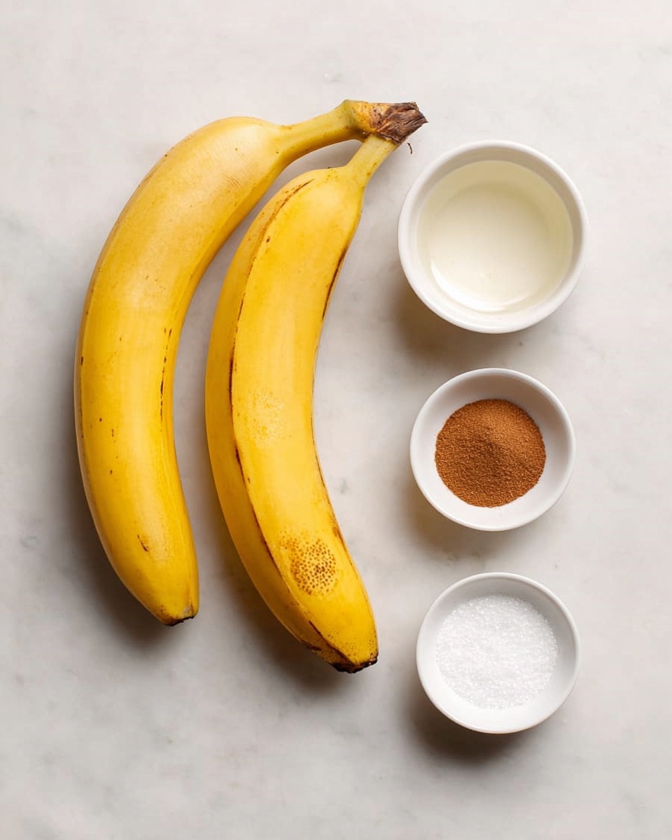 Two yellow bananas with a few brown spots are placed side by side on a white marbled surface. To the right of the bananas are four small white bowls arranged in a loose rectangle: the top right bowl holds a clear liquid, the top left bowl contains white granulated sugar, the bottom left bowl is filled with fine white salt, and the bottom right bowl has a brown cinnamon powder. The scene is simple and bright, with soft natural light. photo taken with an iphone --ar 4:5 --v 7