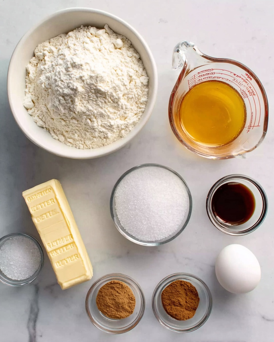 The image shows several baking ingredients placed on a white marbled surface. There is a large white bowl filled with white flour positioned at the top left. To the right of the bowl, there is a clear glass measuring cup filled with melted butter, which is golden yellow. Below the bowl is a stick of salted butter in a yellow wrapper. Next to the butter is a metal measuring cup filled with white sugar. To the right of the sugar, there is a single whole white egg. Below the butter and sugar, there are three small clear bowls arranged in a line, containing white baking soda, white salt, and brown cinnamon powder from left to right. In the middle of these small bowls, there is a small clear bowl with dark brown vanilla extract. The overall setting is clean and organized. Photo taken with an iphone --ar 4:5 --v 7