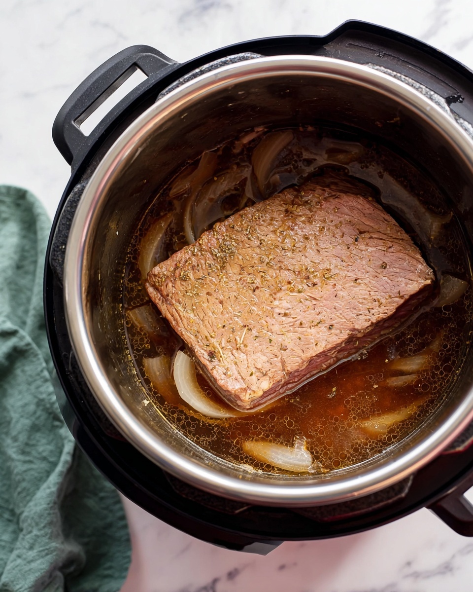 The image shows a large square piece of cooked meat placed inside a black electric cooker with a shiny silver rim. The meat has a light brown color with some visible seasoning and fiber texture on its surface. It is resting on top of large translucent onion slices submerged in a thin brown broth with small bubbles. The cooker is set on a white marbled surface with a folded green cloth partially visible on the left side. photo taken with an iphone --ar 4:5 --v 7