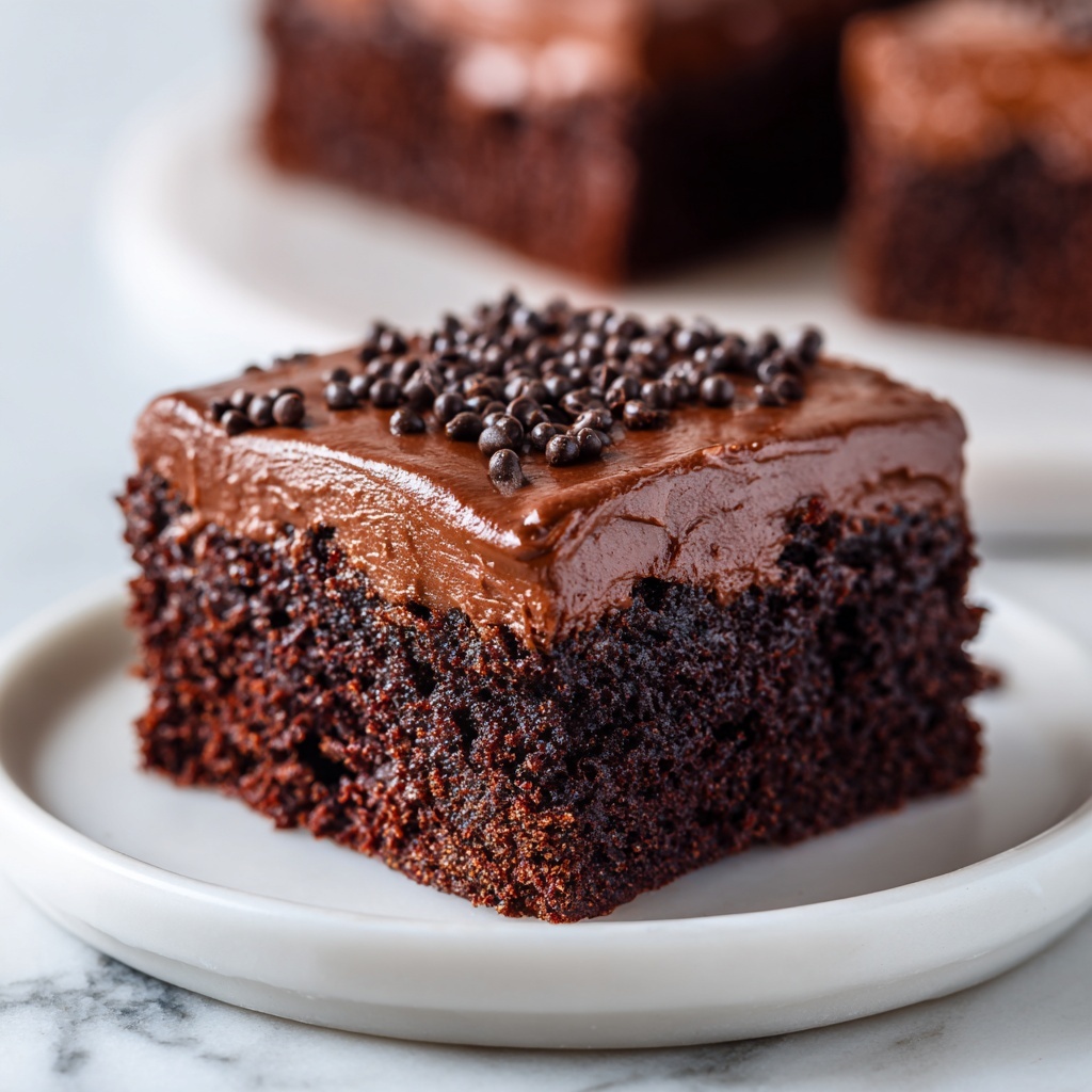 A close-up image of a single square piece of chocolate cake with rich chocolate frosting on top, sprinkled with small chocolate chips. The cake has two visible layers with the bottom layer showing a moist and soft chocolate crumb texture, and the top layer is smooth, glossy, and thick chocolate icing. The cake sits on a white plate with a white marbled surface underneath, and in the background, there is a bottle of soda and more pieces of chocolate cake blurred out. photo taken with an iphone --ar 4:5 --v 7