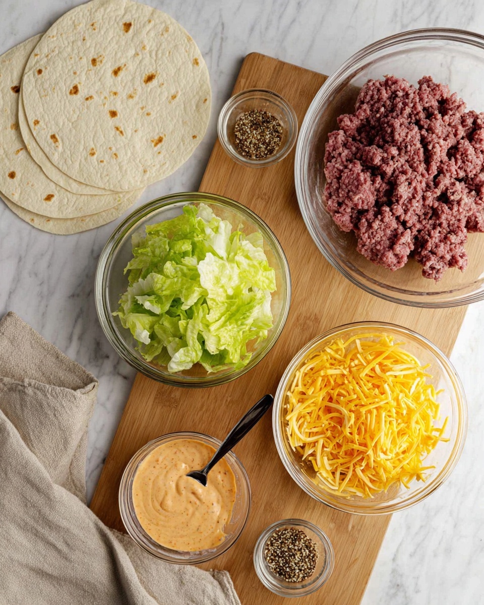 The image shows five clear glass bowls arranged on a wooden board over a white marbled surface. One large bowl contains raw ground meat with a reddish-purple texture. Another large bowl is filled with bright green chopped lettuce, showing layers of crisp leaves. A medium bowl holds shredded yellow cheddar cheese with fine, thin strips. A smaller bowl contains a reddish-orange creamy sauce with a spoon inside, showing a smooth texture. The smallest bowl has a mix of small dark and light seasoning granules. To the left, there are two white tortillas stacked on the board with light brown spots. A beige cloth is draped near the top of the scene. Photo taken with an iphone --ar 4:5 --v 7