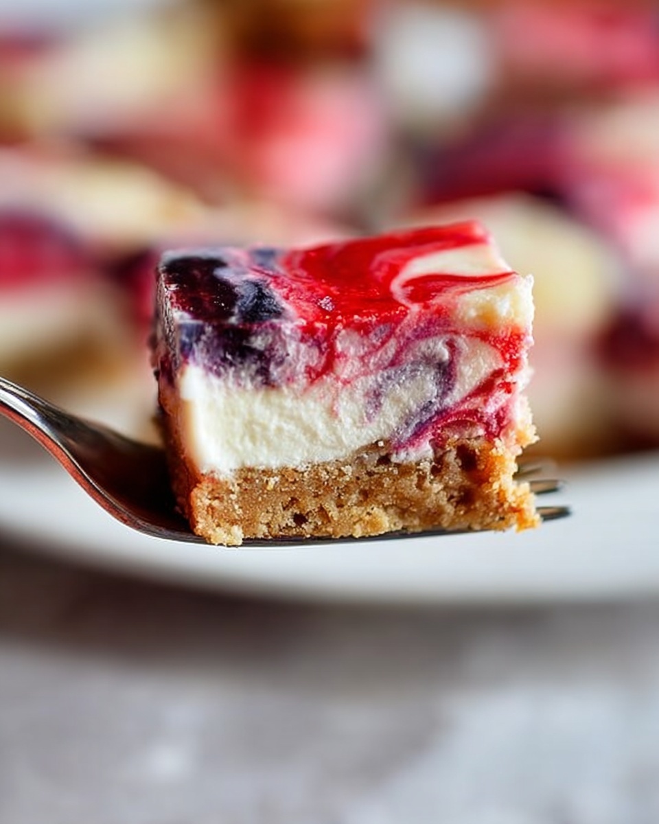 The image shows a close-up of a silver fork holding a piece of layered dessert. The bottom layer is light brown with a crumbly texture, the middle is creamy white and smooth, and the top layer has mixed colors of red, dark purple, and some light pink swirls, giving a marbled effect. The background is blurred but shows the same dessert on a white plate with a white marbled surface underneath. The colors are bright and the textures clear, showing the crumbly base, creamy middle, and fruity topping. photo taken with an iphone --ar 4:5 --v 7