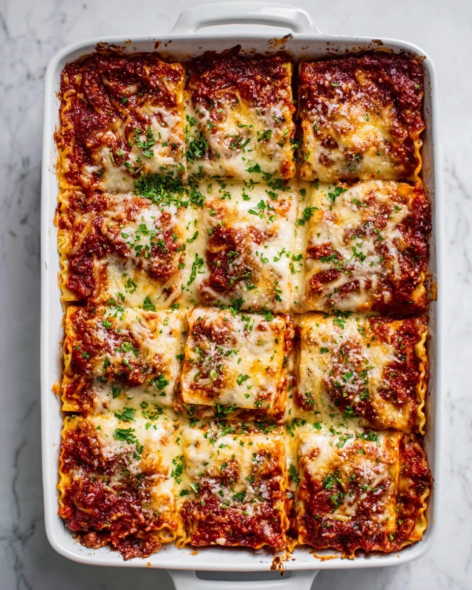 The image shows a white rectangular baking dish filled with lasagna cut into nine square pieces, each topped with a melted layer of golden brown cheese sprinkled with green herbs. The layers underneath consist of rich red tomato sauce and pasta sheets, with visible hints of cheese and sauce blending together for a textured look. The edges of the lasagna are browned and slightly crispy. The dish is placed on a white marbled surface, and the lighting highlights the glossy, cheesy top layer. Photo taken with an iphone --ar 4:5 --v 7