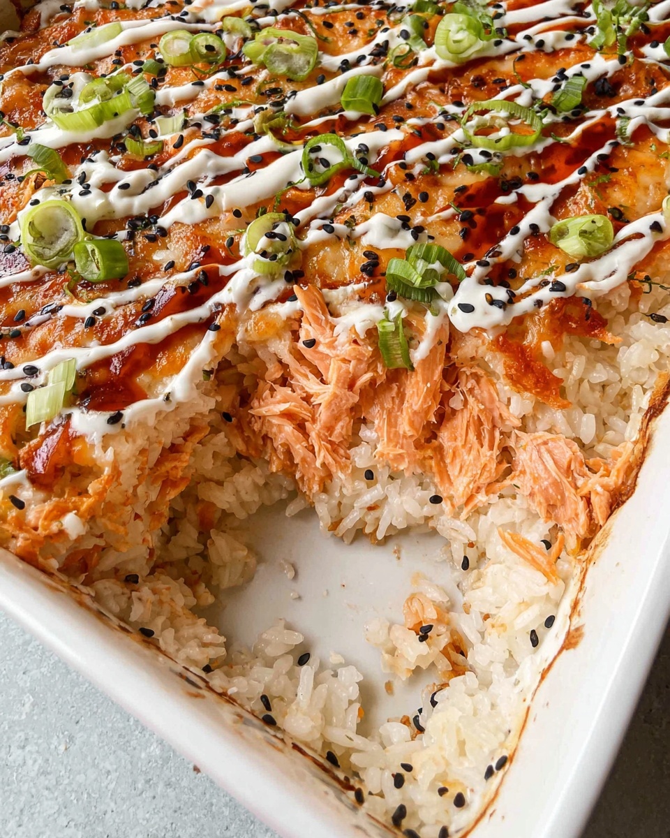 The dish is layered in a white rectangular baking dish with a white marbled texture surface underneath. The bottom layer consists of white rice with a slightly sticky texture and some black sesame seeds sprinkled in. Above the rice is a creamy salmon layer that has an orange-pink color, shredded and mixed to cover the rice. The top layer is a melted cheese layer, golden orange with some brown spots, drizzled with white creamy sauce in a zigzag pattern and a dark reddish sauce. Green onion pieces and black sesame seeds are scattered over the top. One corner of the baking dish is scooped out to show the layers inside. Photo taken with an iphone --ar 4:5 --v 7