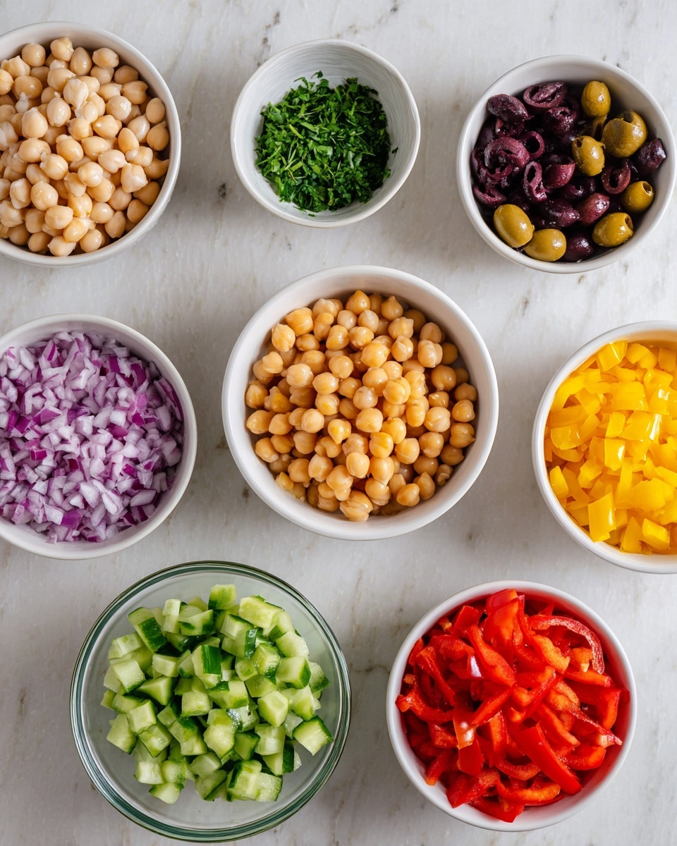 The image shows eight white bowls arranged on a white marbled surface. The central bowl holds light brown chickpeas with a smooth, round texture. Surrounding it, starting from the top left, are bowls filled with creamy white beans, finely chopped dark green herbs, and dark purple sliced olives. On the right side, a bowl contains bright yellow diced bell peppers, and below it, a bowl with finely diced red bell peppers. Below the chickpeas, a bowl is filled with chopped green cucumber pieces, while the bottom left features a smaller glass bowl with finely chopped red onions, showing their purple and white layers. Each bowl shows fresh, colorful ingredients ready for a salad. photo taken with an iphone --ar 4:5 --v 7