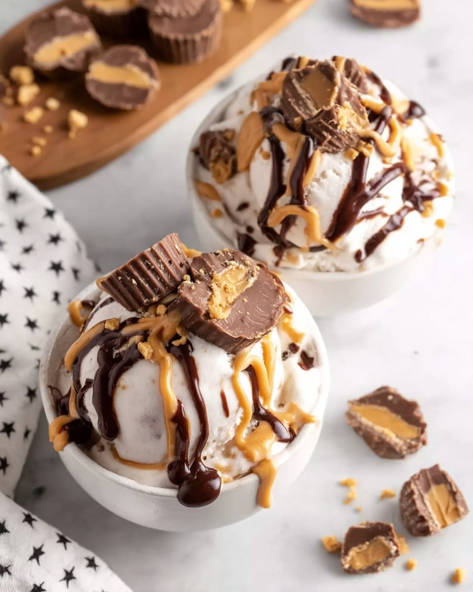 Two white bowls sit on a white marbled surface, each filled with creamy white ice cream as the base layer. On top, thick swirls of light brown peanut butter and dark brown chocolate sauce are drizzled across the ice cream. Scattered over the top are broken pieces of peanut butter cups, showing their textured chocolate shell and creamy filling. In the background, a wooden board with more peanut butter cups is slightly blurred. A white cloth with small black stars is partially visible on the left. The overall look is rich, creamy, and indulgent. photo taken with an iphone --ar 4:5 --v 7