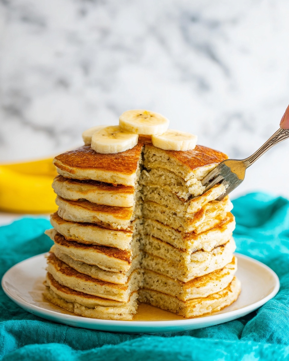 A tall stack of eight thick, golden-brown pancakes sits on a white plate, showing soft, light yellow insides with a slightly grainy texture. A woman's hand holds a fork lifting a piece from the lower right side of the stack. On top, three pale yellow banana slices rest neatly. The plate is set on a bright teal cloth with a white marbled background behind it. photo taken with an iphone --ar 4:5 --v 7