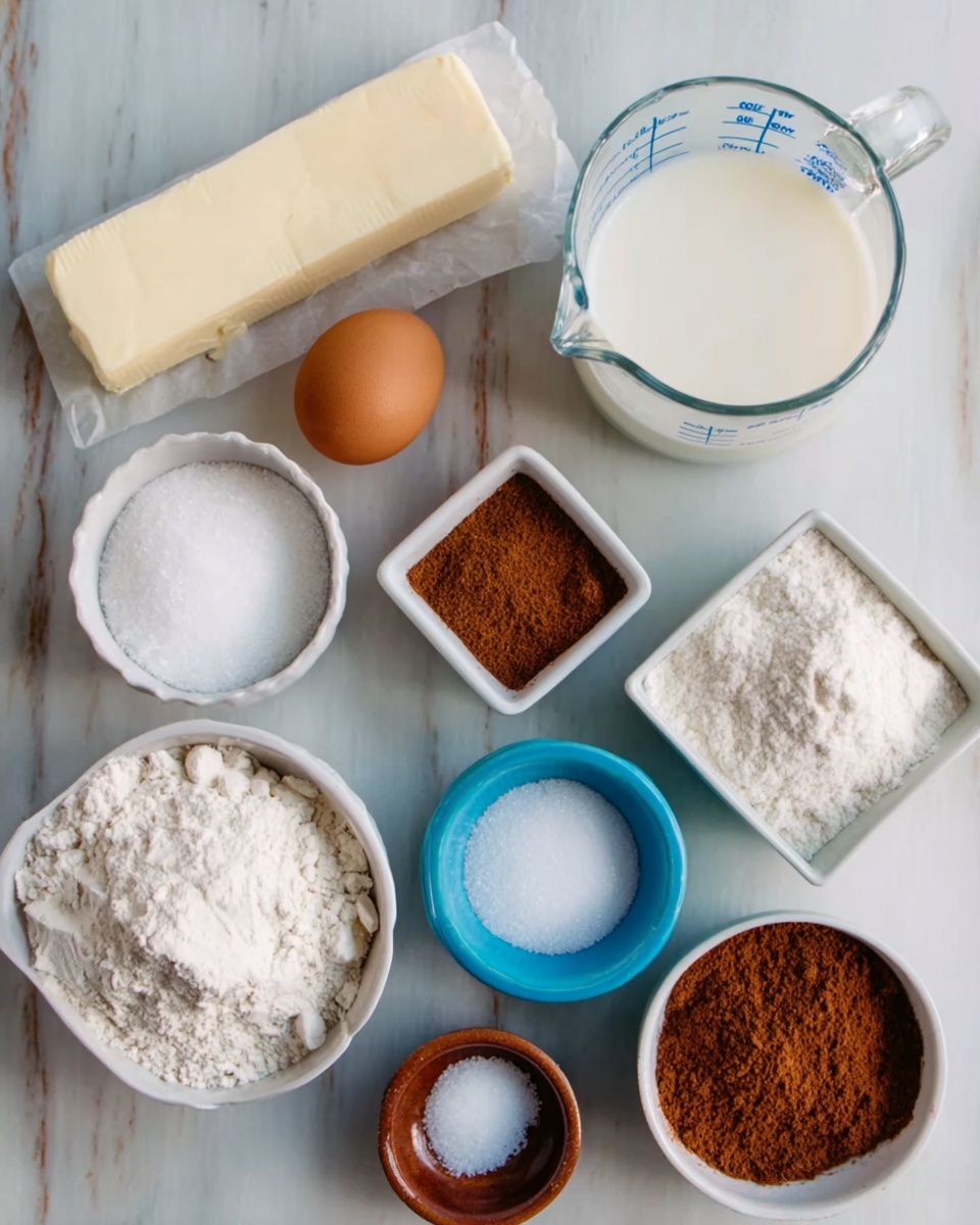 The image shows a white marbled surface with multiple items arranged neatly, including a stick of butter, a white cup filled with white granulated sugar, a brown egg, a white cup of cake flour, a small white square dish with brown cinnamon powder, a transparent glass measuring cup with milk, another white square dish with a darker brown spice, a small blue cup with baking powder, and a small brown bowl with white salt. All items have clear textures and colors, creating a tidy and organized look photo taken with an iphone --ar 4:5 --v 7