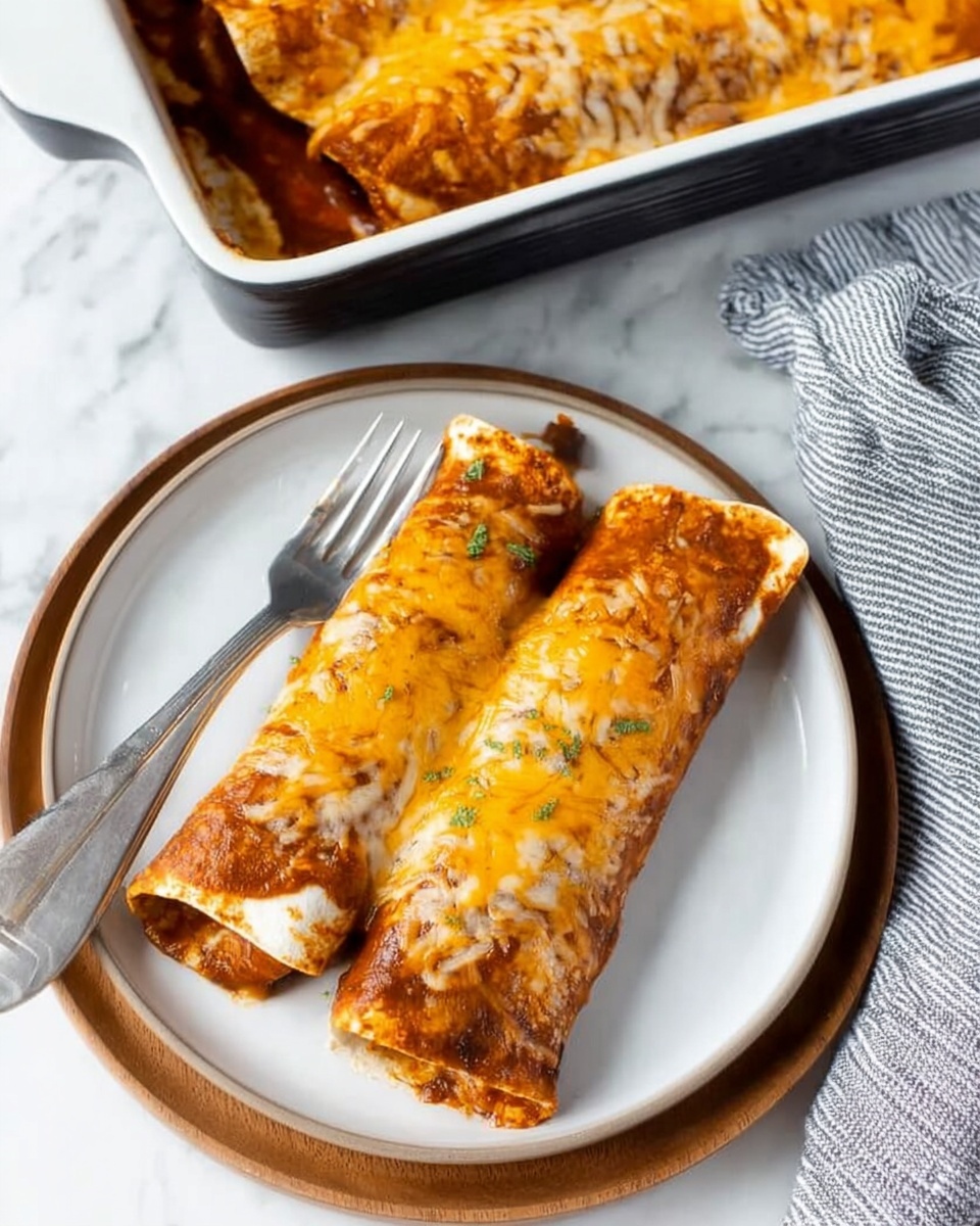 A white baking dish filled with five rolled up white tortillas placed side by side, each covered with a dark red sauce layer and topped with melted shredded cheese that is a mix of golden yellow and light brown colors, creating a textured and slightly crispy look. The tortillas and sauce form the bottom and middle layers, with the cheese as the top layer, melting unevenly over the edges, giving a rich and warm appearance. The dish is set on a wooden surface next to a blue and white cloth. Photo taken with an iphone --ar 4:5 --v 7
