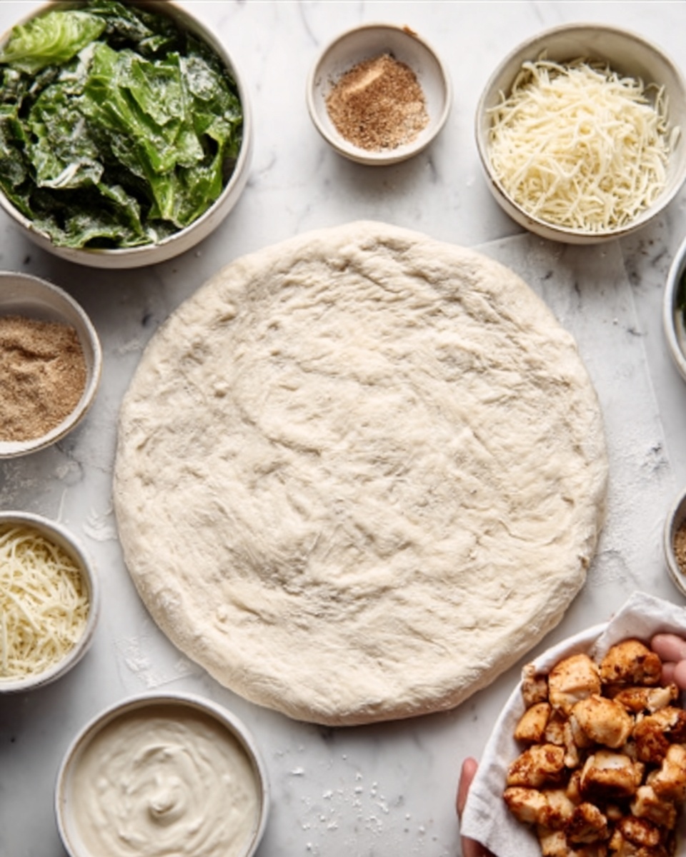 The image shows an uncooked round pizza dough with a slightly uneven surface and light texture, placed flat on a white marbled surface. Surrounding the dough are several small white bowls containing different ingredients: a bowl of green leafy vegetables, a bowl of browned cooked chicken pieces, a bowl of creamy white sauce, a bowl with white shredded cheese, a bowl with light brown spices, and a bowl with a small amount of white salt. A woman's hand is gently holding some cooked chicken pieces on the right side of the image. The scene is bright and clean, ready for assembling the pizza. photo taken with an iphone --ar 4:5 --v 7