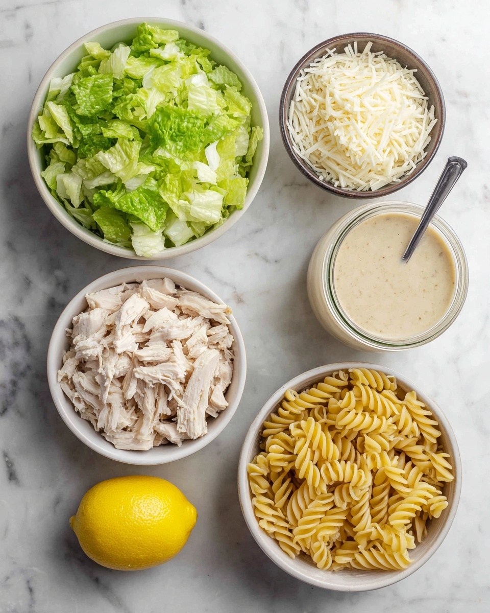 The image shows five separate containers on a white marbled surface, each holding different ingredients. In the top left, a white bowl is filled with chopped bright green lettuce. Below it, another white bowl contains shredded light beige chicken pieces. To the right of the chicken bowl, a small dark brown bowl holds shredded white cheese. Above the cheese bowl, a raw yellow half lemon sits on the surface. In the top right, a glass jar of creamy light beige dressing with a silver spoon inside stands next to a white bowl filled with cooked yellow spiral pasta. The photo taken with an iphone --ar 4:5 --v 7