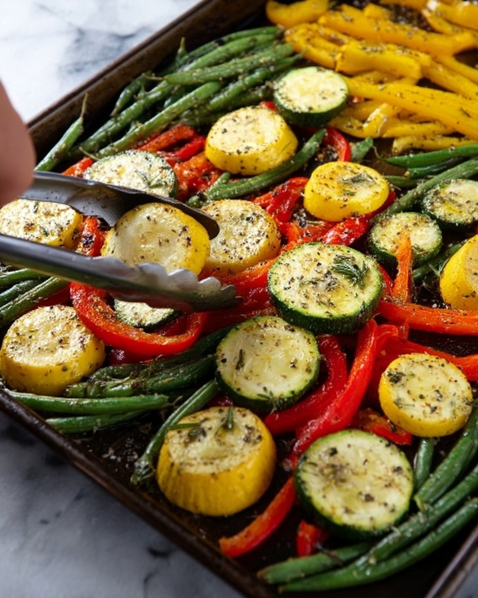 The image shows a tray full of cooked vegetables on a grill. The tray holds three types of vegetables: sliced green zucchini and yellow squash round pieces, long green beans, and thin strips of red bell pepper. All vegetables are sprinkled with black pepper and herbs, giving them a speckled look. The green beans and red pepper strips lie mostly on top and around the round slices. A woman's hand is holding silver tongs above the tray. The background is a white marbled texture. photo taken with an iphone --ar 4:5 --v 7