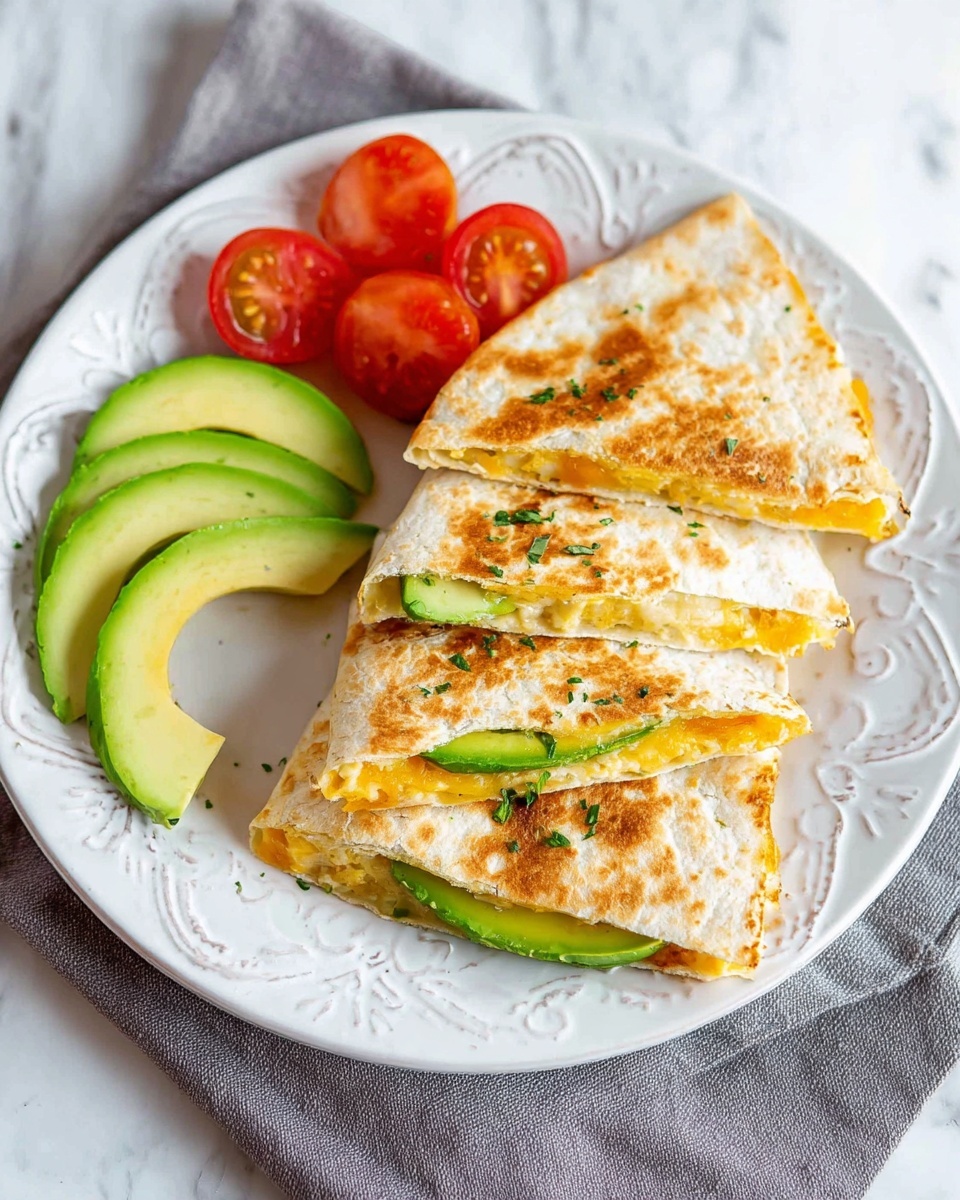 The image shows three triangular slices of a quesadilla arranged on a white plate with a decorative pattern. Each quesadilla slice has a light brown, toasted outer layer with spots of darker brown; inside, there are visible layers of melted cheese in a pale yellow shade and slices of fresh avocado with a smooth green texture. On the side of the plate, there are three thin slices of avocado, light green with a creamy texture, and two slices of bright red cherry tomato, showing their juicy inside. The plate is placed on a gray cloth on top of a white marbled surface. Photo taken with an iphone --ar 4:5 --v 7