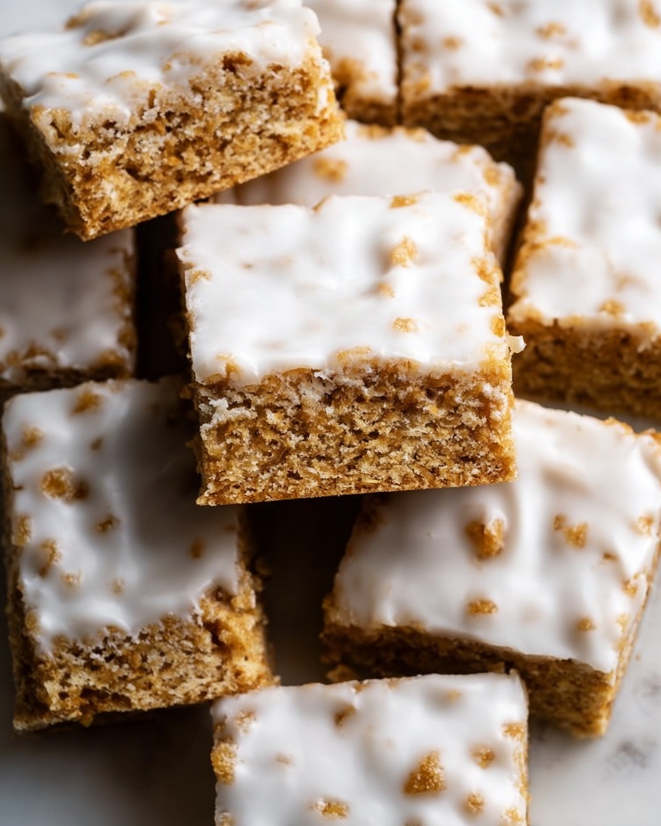 The image shows a stack of five square bars with two clear layers visible in each: a golden-brown base layer filled with oats and small seeds, and a thin, smooth white icing layer on top covering each bar. The bars have rough edges with a crumbly texture, and the top icing layer looks slightly cracked and uneven. Around the stack, several more bars with the same two layers lie flat on a white marbled surface. The close-up view highlights the texture of the oats and seeds in the brown layer, as well as the glossy finish of the icing on top. photo taken with an iphone --ar 4:5 --v 7