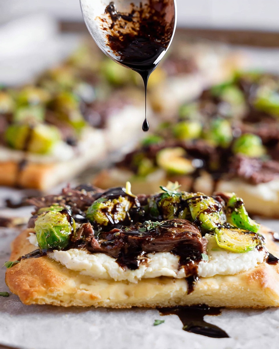A close-up shot of a slice of flatbread pizza held by a woman's hand, showing three main layers: the flatbread base which is light beige and slightly toasted, topped with thick slices of medium-rare steak that are pink in the middle and brown on the edges, and bright green roasted Brussels sprout leaves scattered on top. The pizza is drizzled with a dark balsamic glaze that contrasts vividly against the green leaves and light flatbread. The background is softly blurred, featuring more slices of the same pizza on a white marbled surface. Photo taken with an iphone --ar 4:5 --v 7
