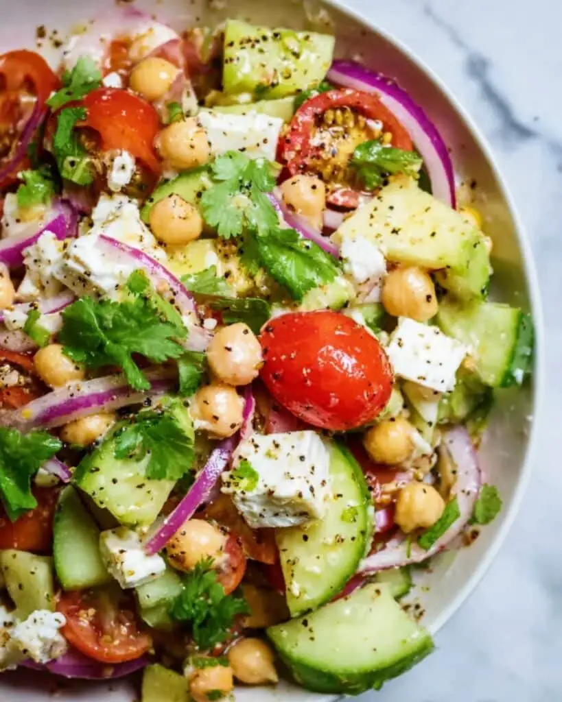 Refreshing Chickpea Salad with Cherry Tomatoes, Cucumber, Avocado, and Feta Recipe