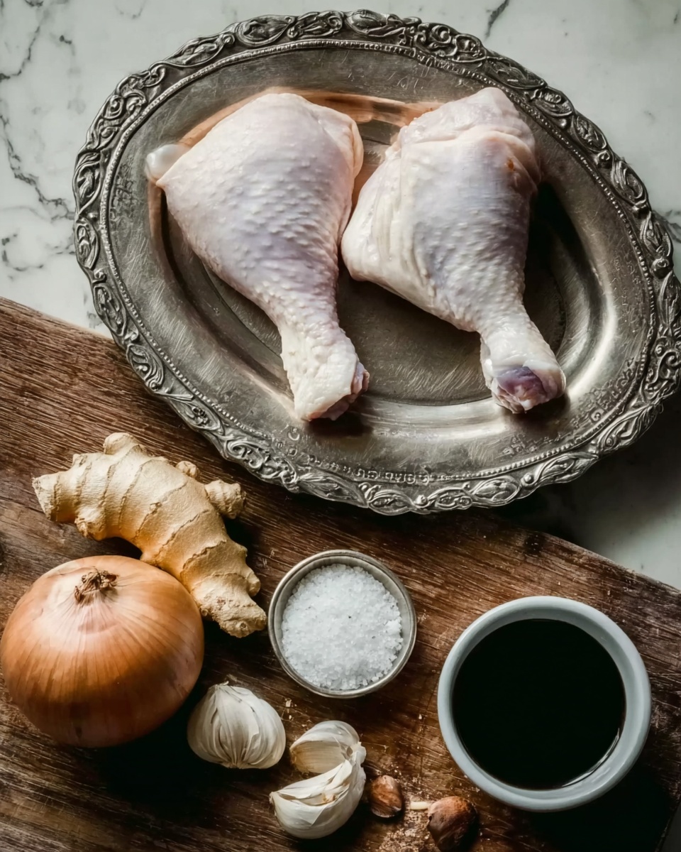 The image shows two raw chicken legs with pale skin placed on a silver metal plate with detailed edges. Below the plate is a wooden surface holding three garlic cloves, a cluster of garlic with the skin on, a whole brown onion, a piece of fresh ginger root, a small white bowl filled with coarse white salt, and a small dark container filled with black liquid. The background is a white marbled texture. Photo taken with an iphone --ar 4:5 --v 7