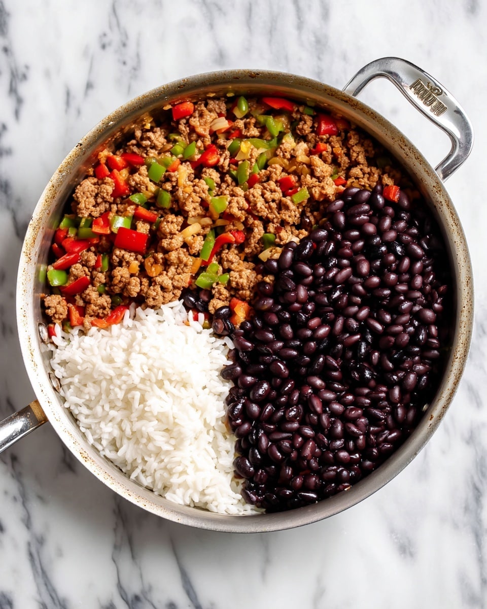 The image shows a metal pan placed on a silver cooling rack over a white marbled surface. Inside the pan, there are three clear sections of ingredients: one section filled with cooked ground meat mixed with green and red bell peppers and onions, showing a textured and colorful mix; the second section has plain white rice with a soft, grainy texture; the third section contains dark black beans that look smooth and shiny, all placed side by side in the pan without mixing. Photo taken with an iphone --ar 4:5 --v 7