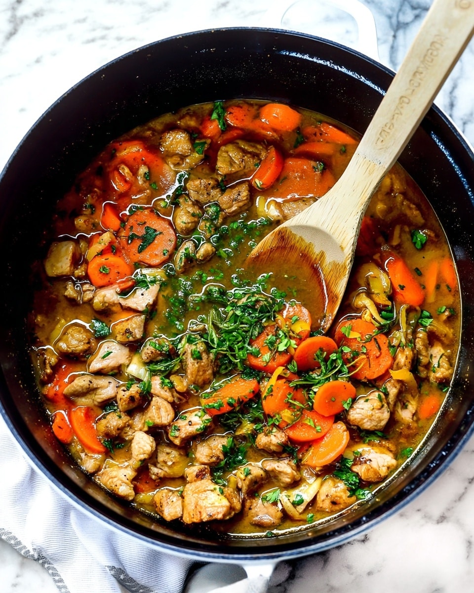 The image shows a black pan filled with a stew-like dish. The dish has a base layer of rich brown broth with small chunks of cooked light brown meat scattered all over. On top, there are bright orange carrot slices evenly spread throughout. Fresh green chopped herbs are sprinkled over the entire dish, adding a touch of color and freshness. A wooden spoon rests on the right side of the pan, partially submerged in the stew, with the spoon’s surface showing some broth and oil stains. The pan is placed on a white marbled surface with a white cloth partially visible under the pan. photo taken with an iphone --ar 4:5 --v 7